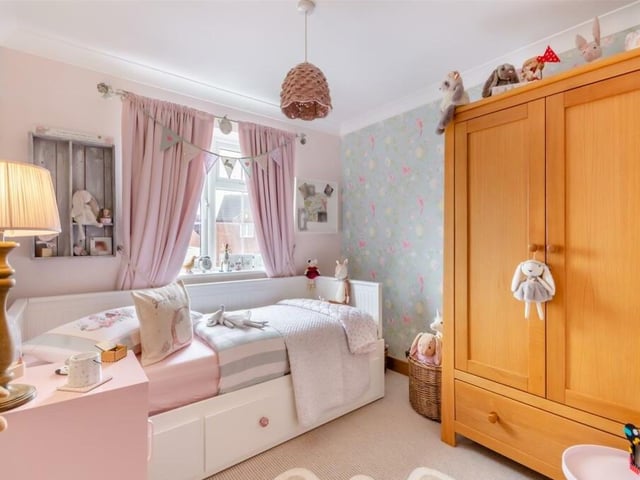 There is plenty of wardrobe space within this happy bedroom, which could be ideal for a young child. It overlooks the front of the house.