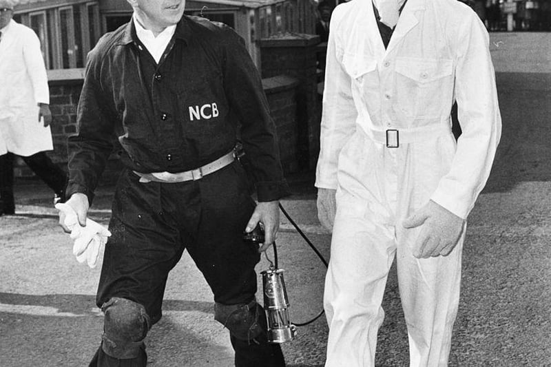 Prince Charles wearing a miners helmet and white overalls as he talks to General Manager W Barrett during a visit to Welbeck Colliery, on July 19th 1968.