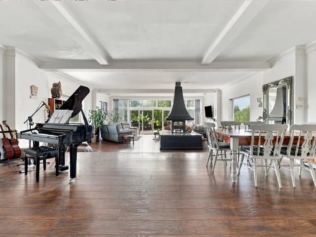 The main living space forms the central heart of the home, with a show-stopping log burner