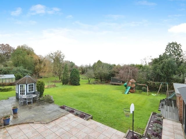 This is a terrific overhead shot of the pleasant patio area in the rear garden, and also the quirky summer house.