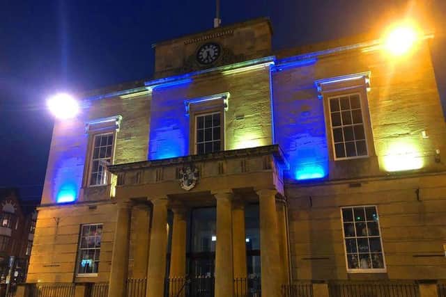 Mansfield Old Town Hall illuminated in blue and yellow