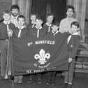 Members of the Mansfield 9th Scouts show off a new Flag in 1990.