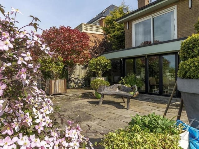 The last photo in our gallery focuses on the pleasant, tiled patio at the back of the £400,000 bungalow.