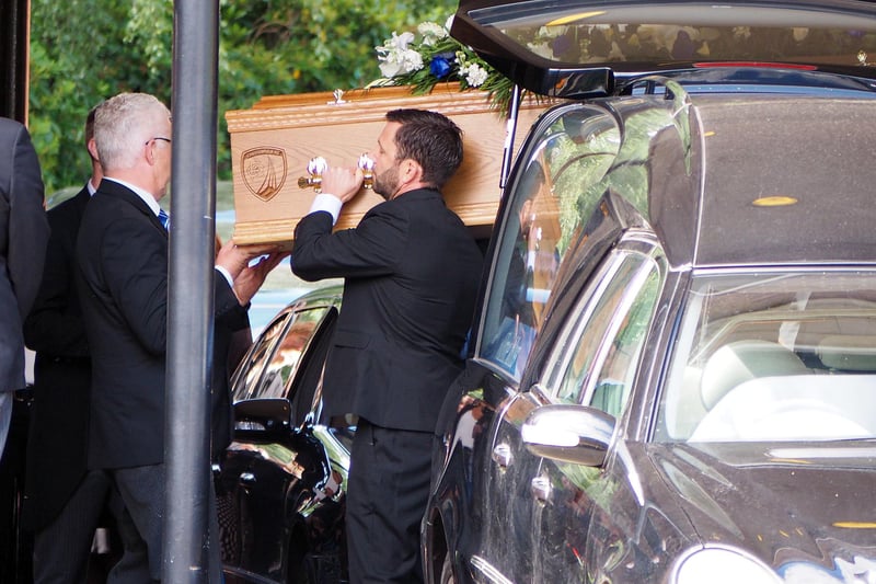 Ernie is carefully carried into the crematorium for his funeral service.