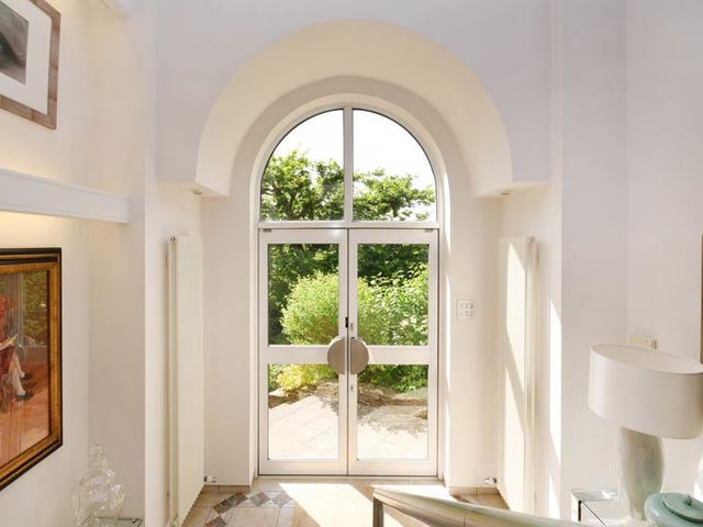 An atrium style reception hall makes an "immediate positive impression", having arched windows, Italian tiling, stairs with a polished steel and a glass balustrade, and a contemporary water feature.