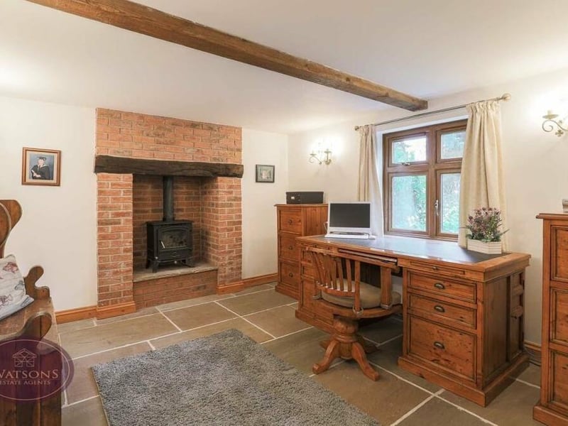 The attractive study at The Three Horseshoes boasts another of the period property's feature fireplaces. It is brick-built with an inset multi-fuel burner. Slate tiled flooring adds to the charm of the room.