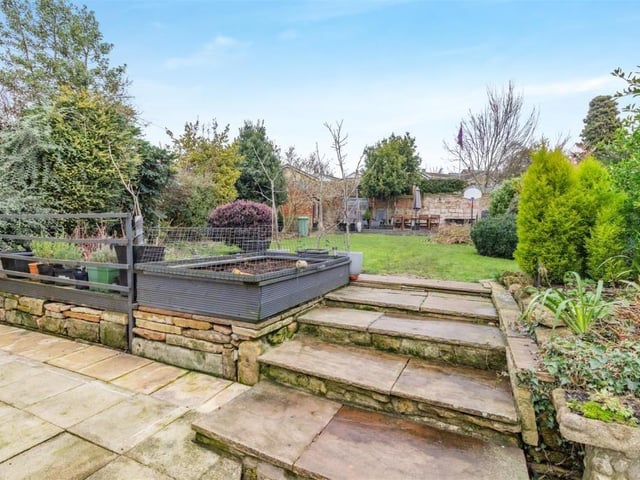 The main garden at the £585,000 Whitwell property is full of character, with patio areas, pathways, a lawn, plants, shrubs, flowerbeds and trees.