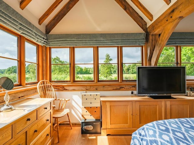 Bright and spacious, the master bedroom offers breathtaking views over the surrounding paddock and gardens.