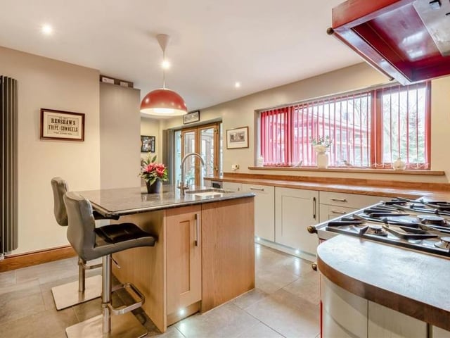 Next stop at the £550,000 house is the kitchen/breakfast room, which includes a central island with granite work surface and an inset sink with swan-neck mixer tap. A range cooker with five-ring gas hob is included in the sale.