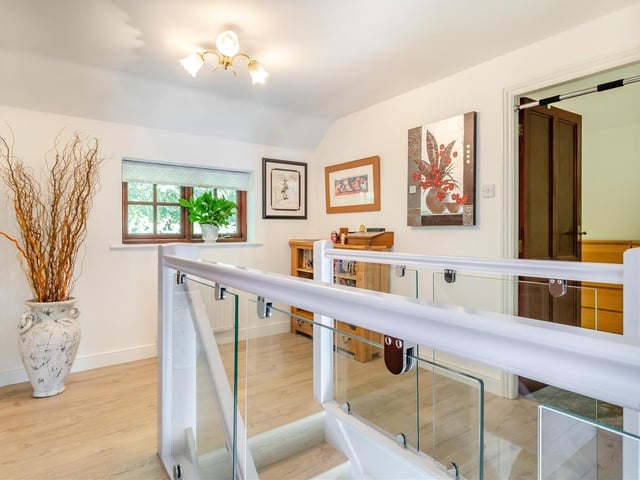 At the top of the stairs, you are greeted by a galleried landing, which has an oak laminate floor and houses an airing cupboard.
