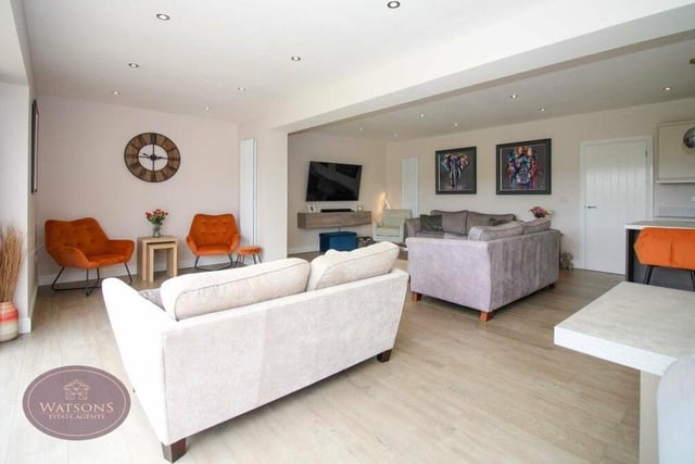 The open-plan living area offers a huge amount of space, with room for several sofas, and is typical of the modern decor throughout the renovated property.