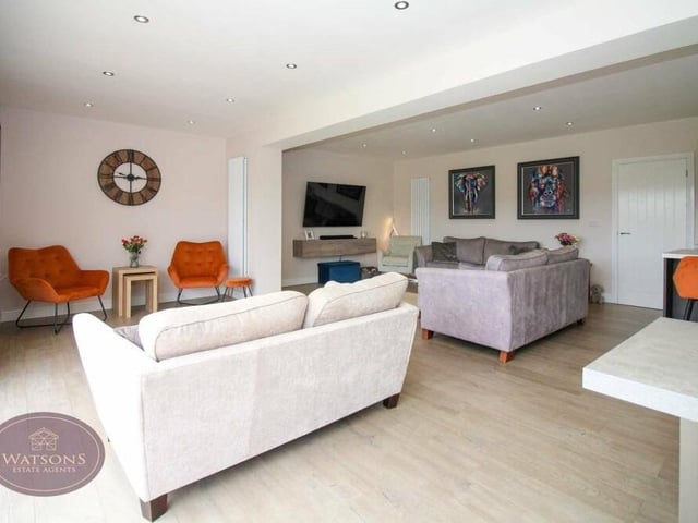 The open-plan living area offers a huge amount of space, with room for several sofas, and is typical of the modern decor throughout the renovated property.