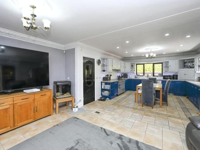 The living room opens out into the luxurious kitchen, which features a range cooker point, gas hob with extractor over, and integrated fridge freezer and dishwasher. There is a range of wall and base units with work surfaces over, plus a one-and-a-half-bowl sink unit with mixer tap.