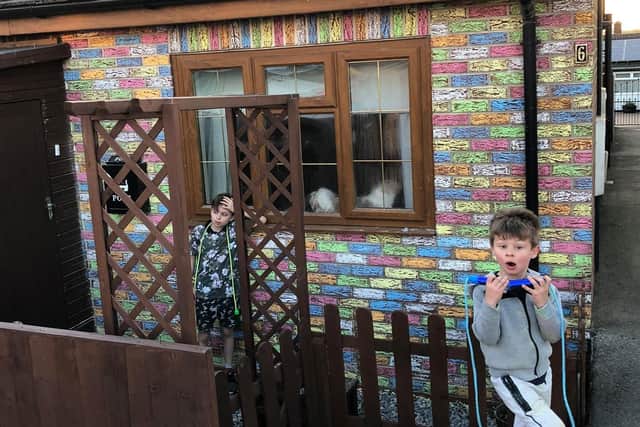 Elliott and Ethan Cater coloured in their grandma's bungalow in rainbow colours