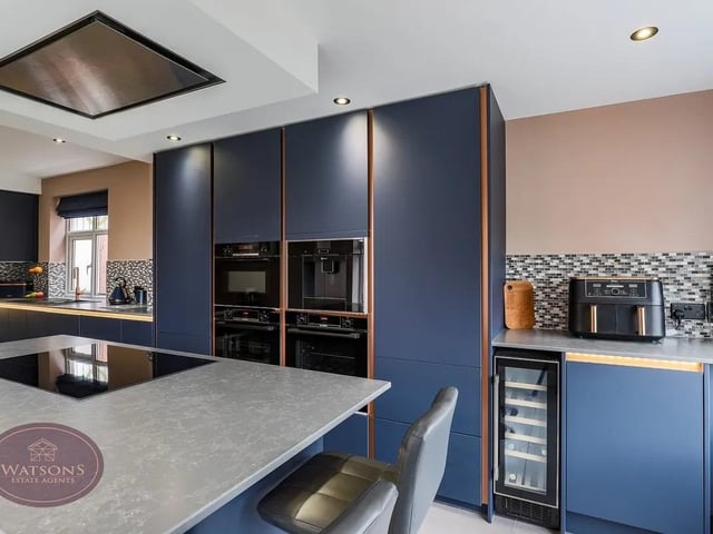 The superb modern dining kitchen complete with central island and underfloor heating—creates the true heart of the home