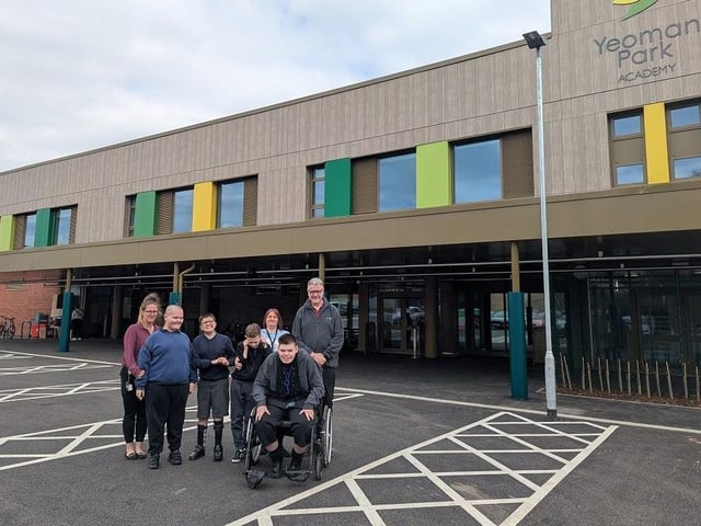 Principal Courtney Hoop with young learners outside the new Yeoman Park Academy building