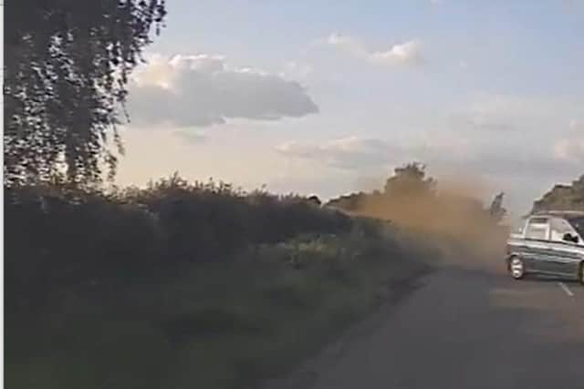 The car veered off into the grass verge and collided with the police vehicle