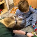 A typical example of a member of staff helping a young child to learn at Kidzgrove Daycare nursery in Mansfield Woodhouse, which has been given a rating of 'Good' by the education watchdog, Ofsted.