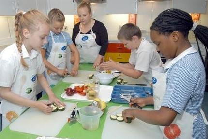Michaela Bowles, centre, a teacher with Focus on Food pictured with pupils of Rainworth's Heathlands School when the Cooking Bus visited the school.
