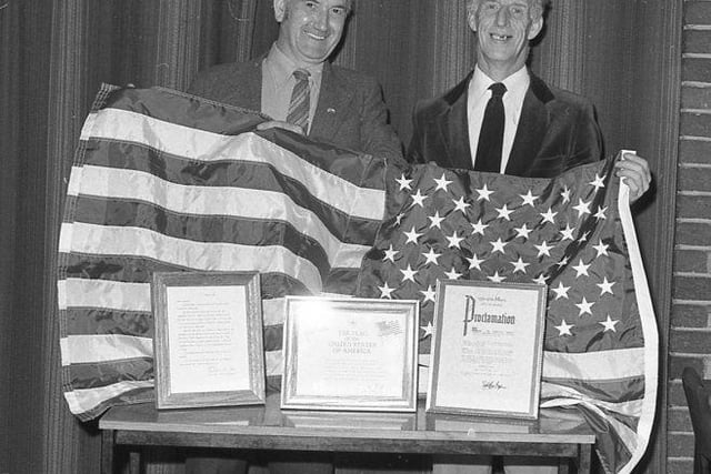 Geoff Piggin and Lol Foster presented with a US flag at Mansfield Colliery Welfare in November 1981