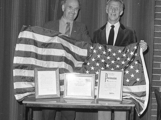 Geoff Piggin and Lol Foster presented with a US flag at Mansfield Colliery Welfare in November 1981