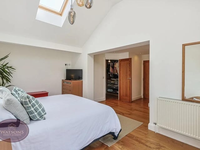 Superb primary suite with vaulted ceilings, Juliet balcony with breathtaking countryside views, dressing room, walk in wardrobe and luxurious en suite.