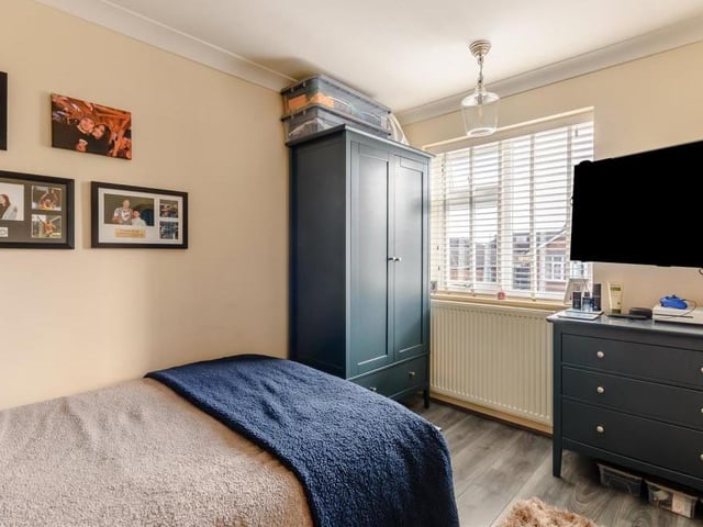 The third bedroom is smaller than the main two but still has room for a wardrobe, desk and TV. The floor is laminated and the window faces the side of the house.