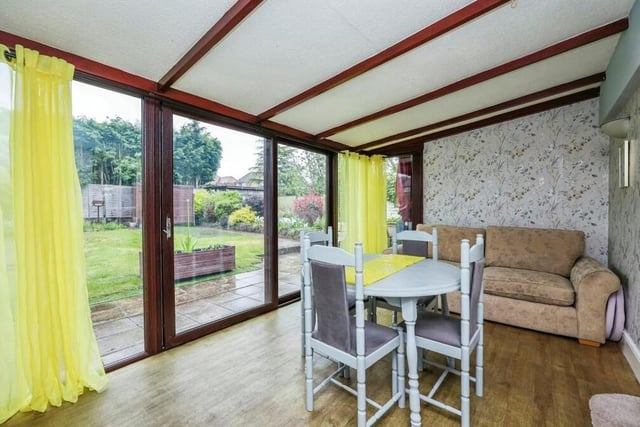 Flowing seamlessly from the lounge is this eyecatching dining room, which includes double-glazed patio doors leading to the back garden. It has a vinyl floor and wall lights.