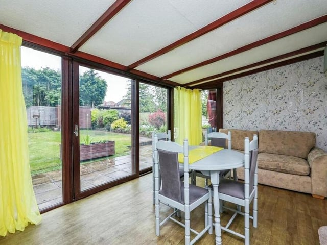 Flowing seamlessly from the lounge is this eyecatching dining room, which includes double-glazed patio doors leading to the back garden. It has a vinyl floor and wall lights.