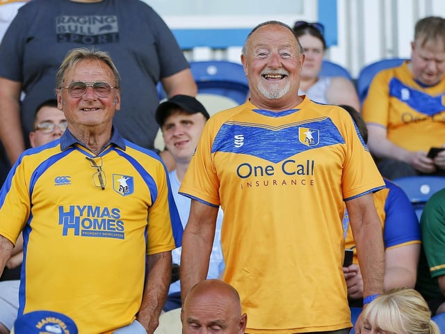 Mansfield Town fans watch the Carabao Cup first round match against Derby County.