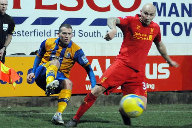 Louis Briscoe clears the ball while under pressure from Jon-Jo Shelvey in the FA Cup defeat to Liverpool. Pic by Anne Shelley.