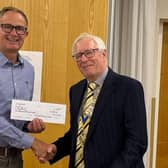 Picture shows George Nelson, left, receiving a cheque from Rotary President Paul Bacon.