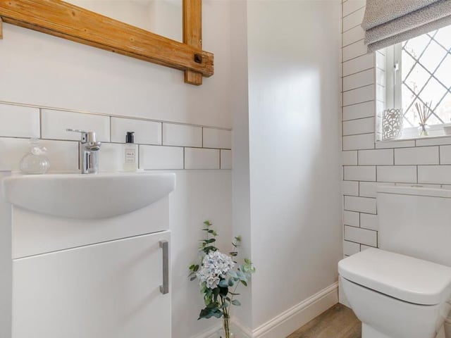 The ground floor of the Granby Avenue property also includes this cloakroom/WC, which is fitted with a contemporary, two-piece suite. It comprises a low-flush WC, vanity unit with inset wash hand basin, vinyl floor and chrome, heated towel-rail.