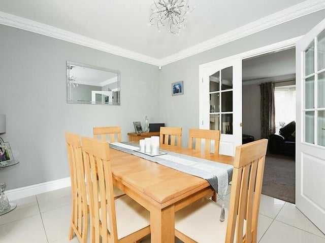 From the lounge, another set of doors guides you into this dining room. As with all the rooms in the house, it is so well presented.