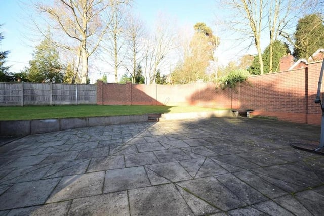 As we say farewell to the £895,000 property in Ravenshead, let's nip back outside to take a look at this sizeable, paved patio area. Lovely for relaxing on a warm summer's day or even hosting barbecues for family and friends.