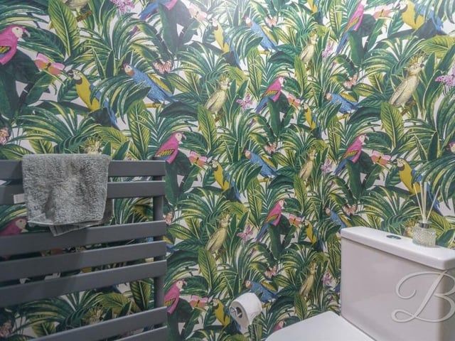 If you can make it out through the colourful wallpaper (lol!), this is the downstairs toilet. It includes a low-flush WC and hand wash basin.