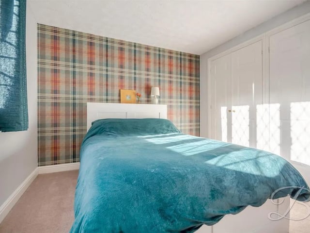 One of five spacious bedrooms in the family home.