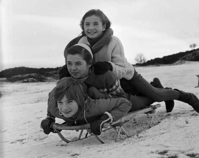 Three girls sledging on the Braid Hills in 1964.
