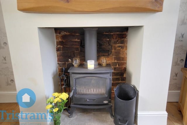 The character of the living room is enhanced considerably by this fitted log-burner.