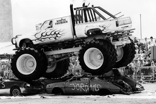 The giant White Thunder Monster Truck, making a meal of four cars as it rides over them in the Southsea Show arena, 1993. The News PP5208