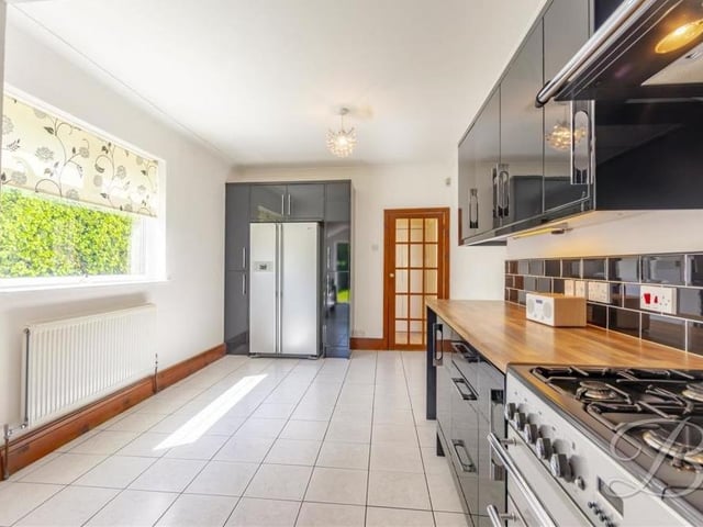 A built-in fridge/freezer is another huge asset to the classy kitchen, seen here from a different angle.