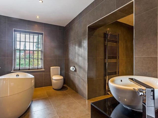 The first floor boasts two bathrooms, including this one, which has a distinctive egg-shaped Villeroy and Boch bath. It also features twin Villeroy and Boch hand wash basins, a walk-in Drench shower, a low-flush WC, a spiral, heated towel-rail and modern tiling throughout.