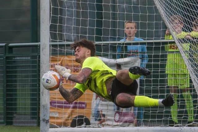 Thomas Smith makes a save for Kimberley in the penalty shoot-out. Photo by Step Five Media.