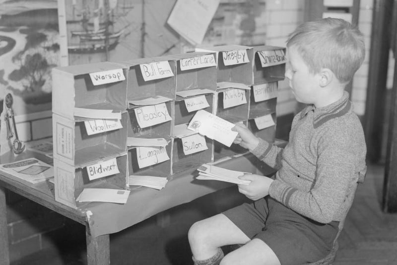 A young letter sorter at work at King Edward Infants School's miniature post office in 1935.