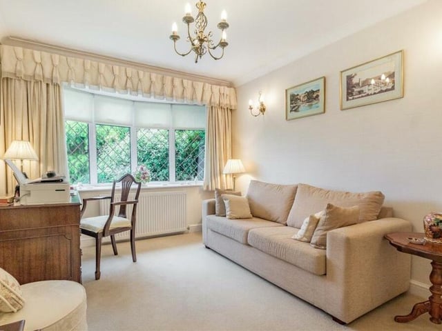 The second bedroom at the Beverley Drive bungalow is currently being used as a pleasant sitting room or study. With coving to the ceiling, it boasts a large window that faces the front of the property.