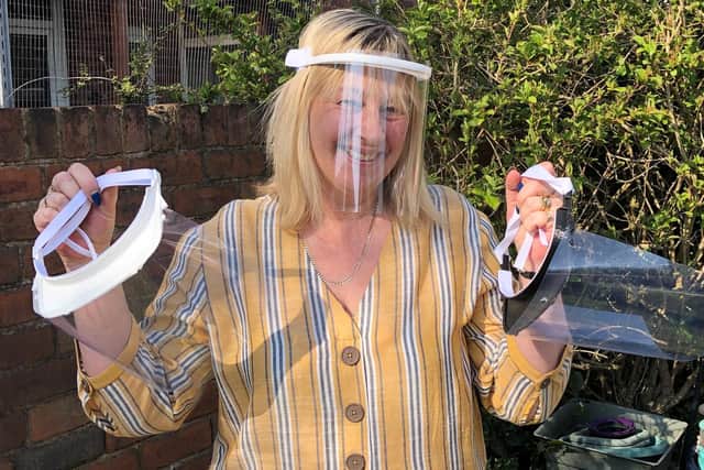 Trudi Dean wearing one of the masks that the team is making