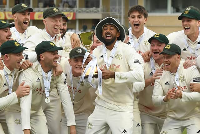 Haseeb Hameed lifts the County Championship Trophy with team-mates.