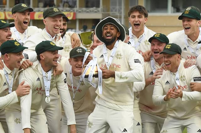 Haseeb Hameed lifts the County Championship Trophy with team-mates.
