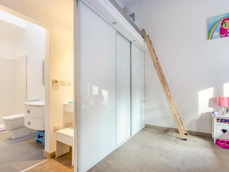 Here is a close-up of the wardrobes in the second bedroom and also the en suite facilities. But what is that ladder for?......
