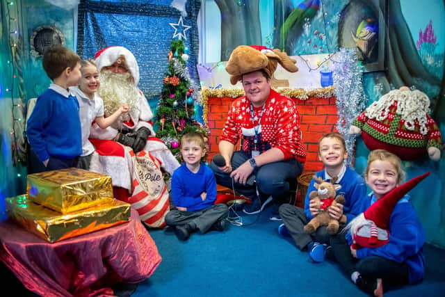 Santa Claus and the BBC’s Rob Rose (third from right) with Bilsthorpe Flying High Academy children in their school grotto